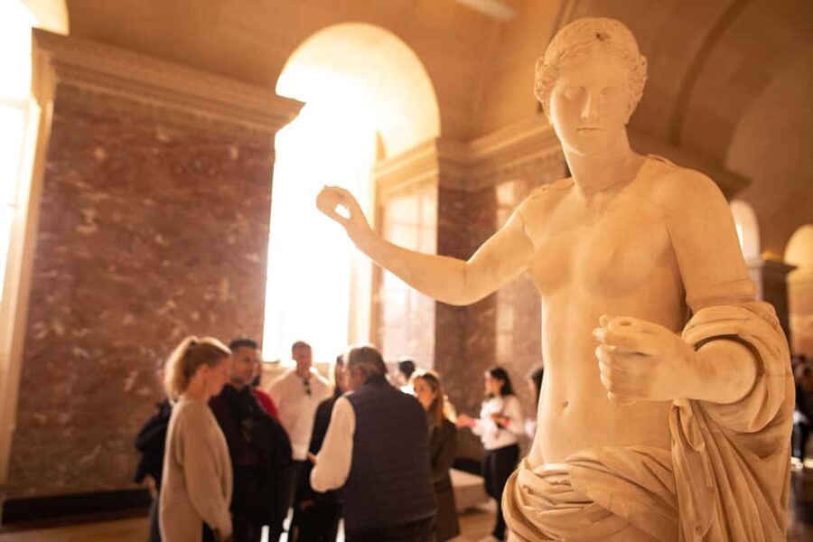 Paris Louvre Exclusive Semi Private Guided Tour Max 6 People - Passing the Louvre Pyramid and setting the route