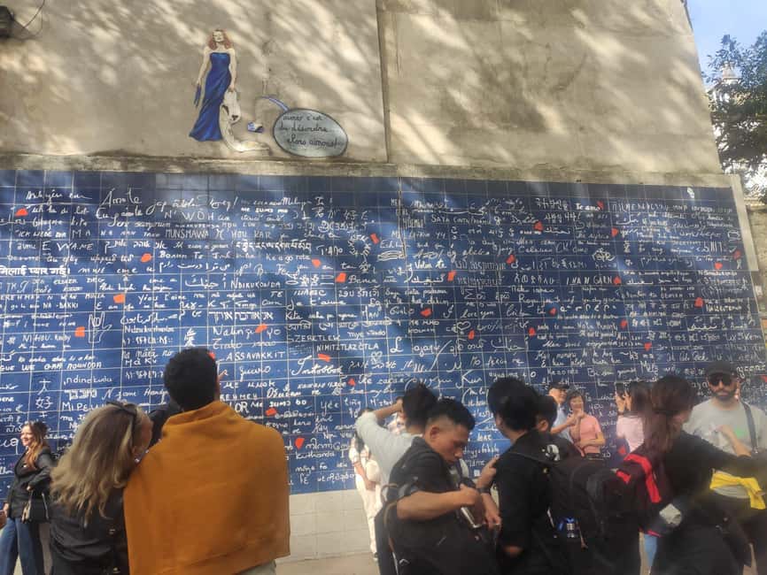 Paris : Montmartre highlights walking tour - Moulin Rouge Area: Photos, Windmill Icon, and Street Atmosphere