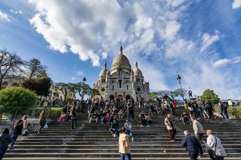 Paris: Montmartre Highlights Walking Tour with a Local Guide - Place Saint-Pierre to the Wall of Love, a photo stop with meaning